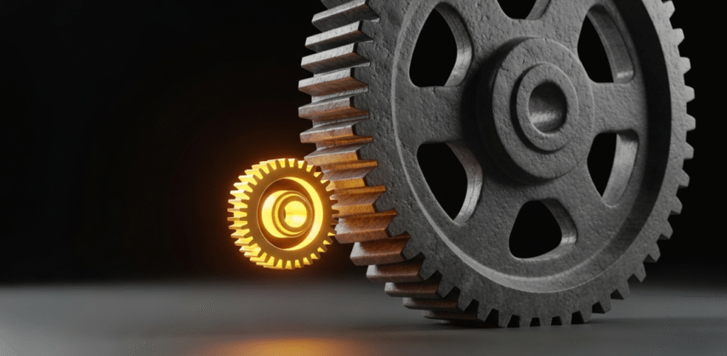 Grande engrenagem comecando a girar com o empurrao de uma pequena engrenagem dourada representando como vencer a procrastinacao